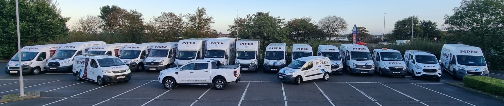 The Piper Windows fleet of branded vans and lorries lined up side by side