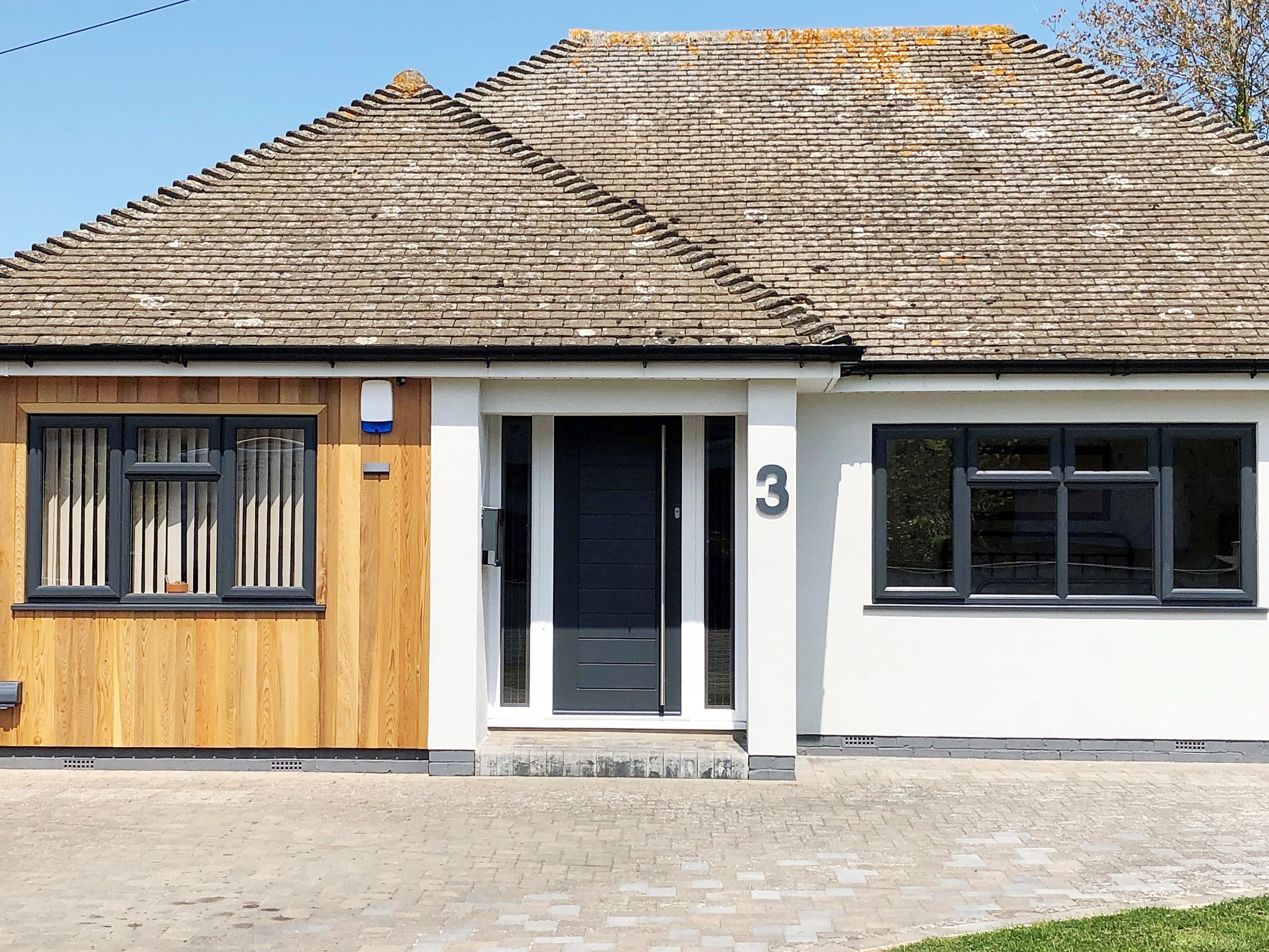 Bungalow with anthracite windows, a composite door and cedar cladding