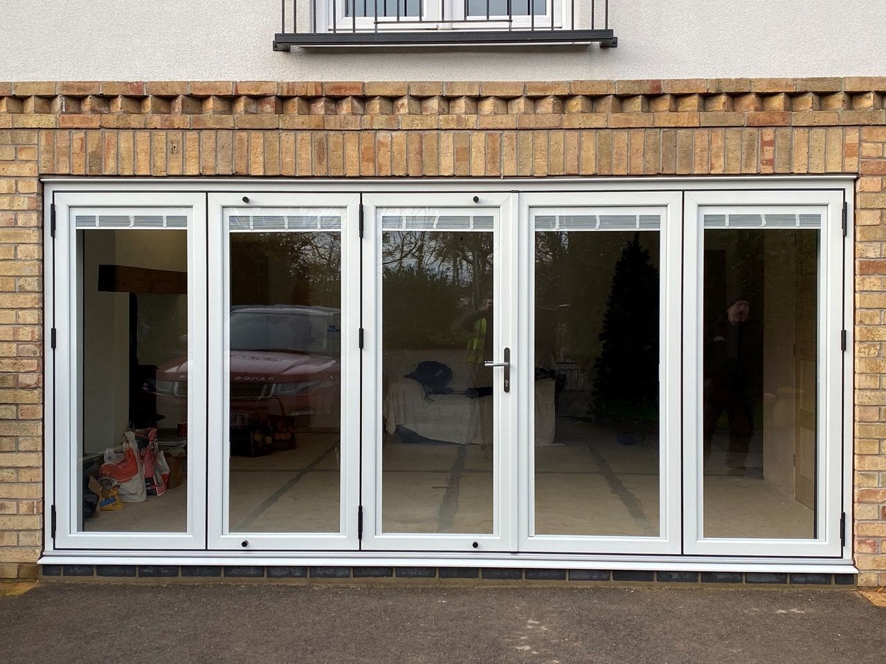 White bifolding doors opening on to a garden