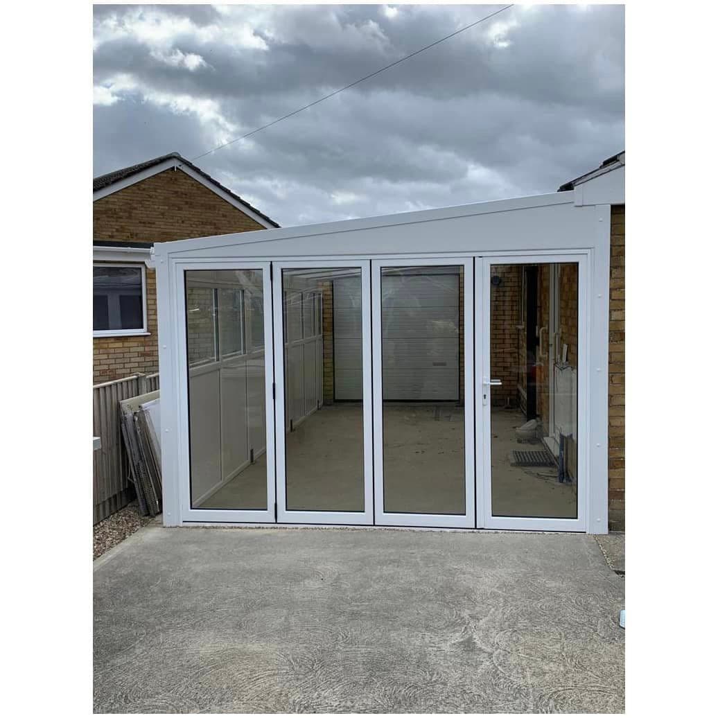 Four leaf white glazed doors closed across the front of a white framed structure