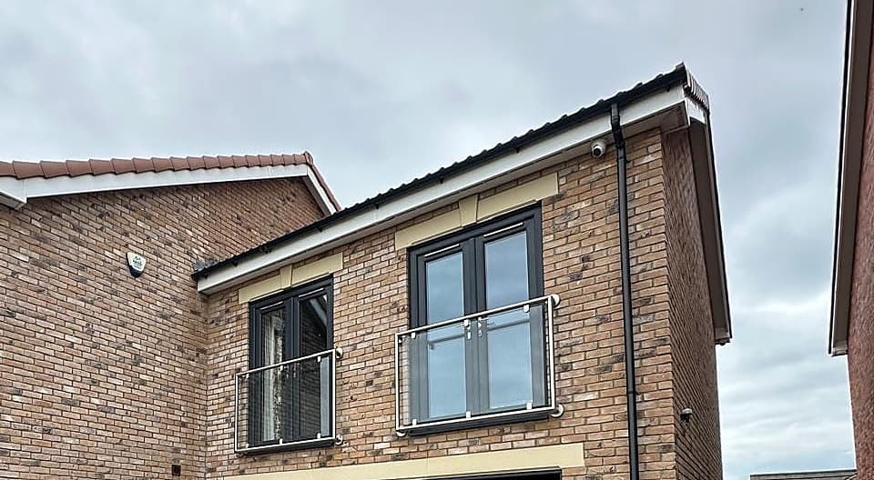 Two Juliet balconies in glass and stainless steel in front of first floor doors