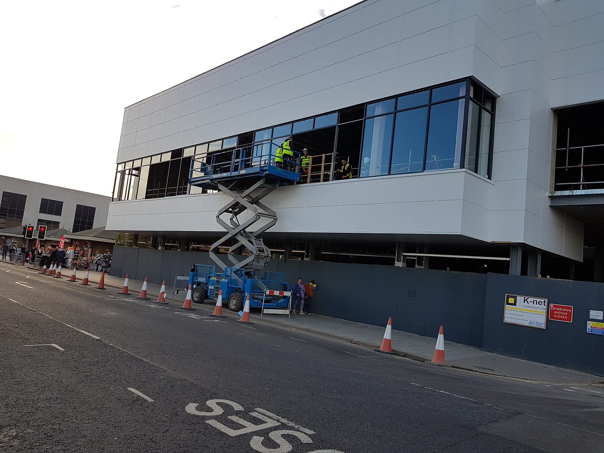 Dark framed glazed screens going into the first floor of a town centre building