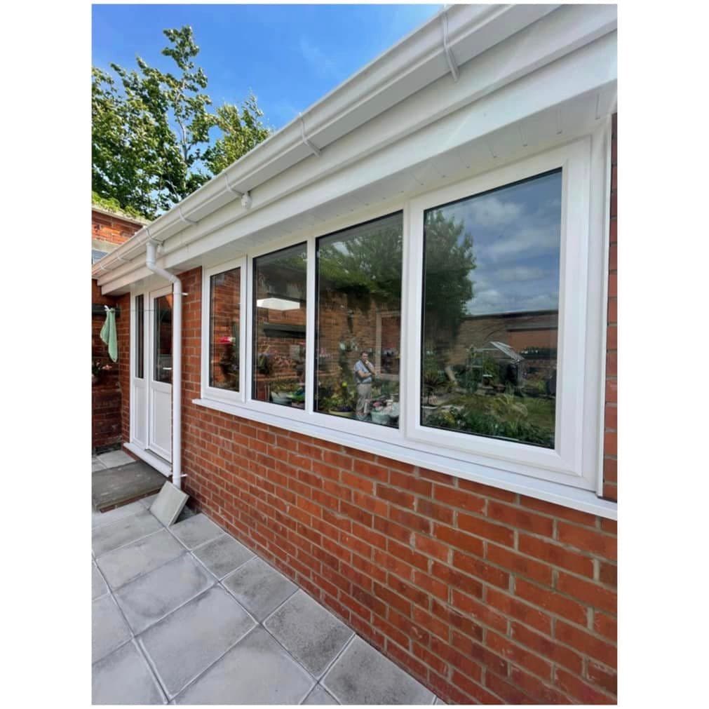 White window run and white roofline on a single storey brick building